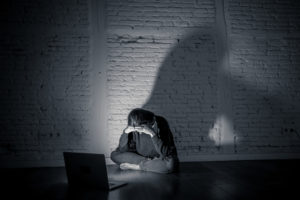 girl crying in front of laptop