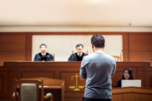 man standing in front of two judges