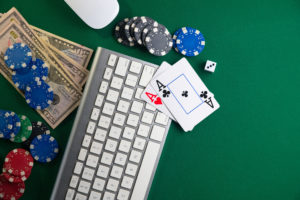 poker chips, playing cards, cash, and a keyboard