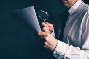 lawyer examining footnote with magnifying glass