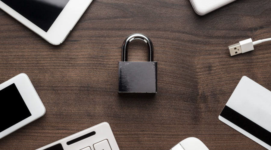 padlock and different gadgets on the wooden office table. privacy protection, encrypted connection concept, buying online